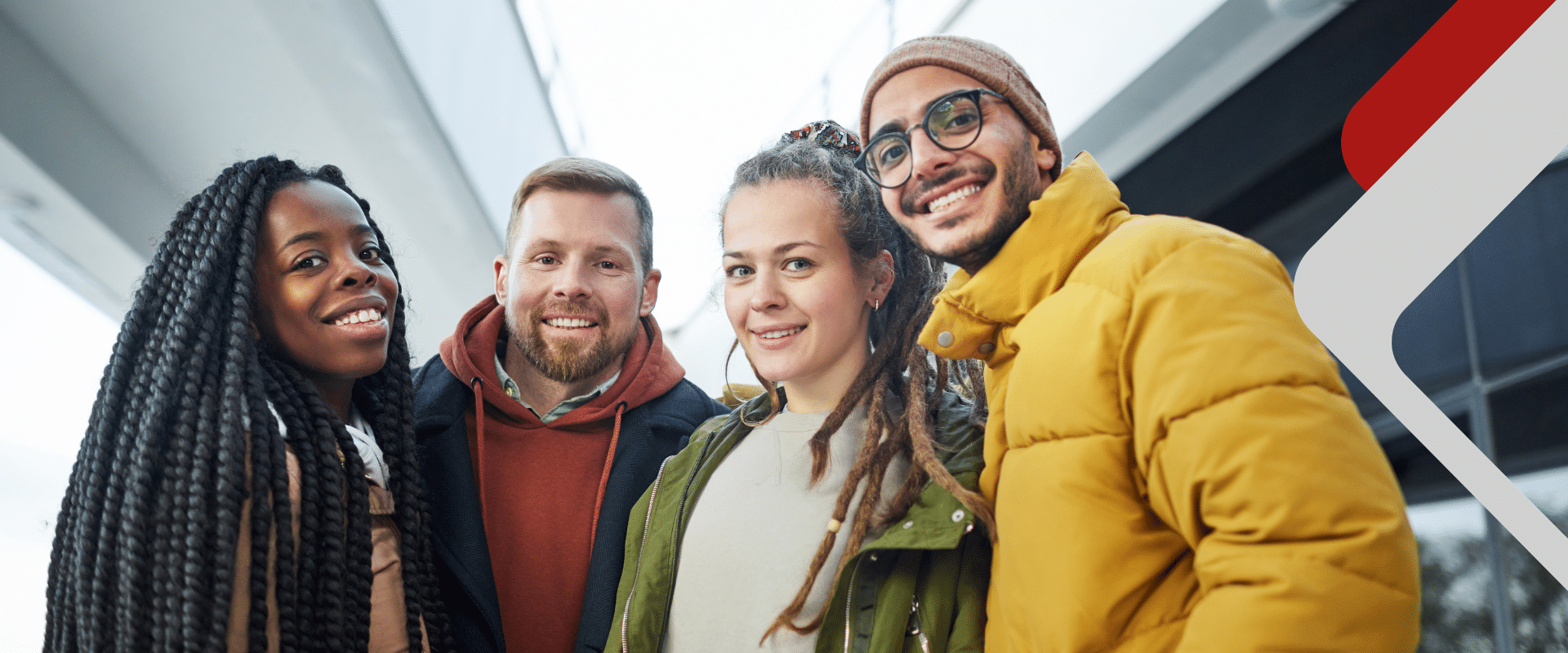Vier junge Menschen lächeln in die Kamera